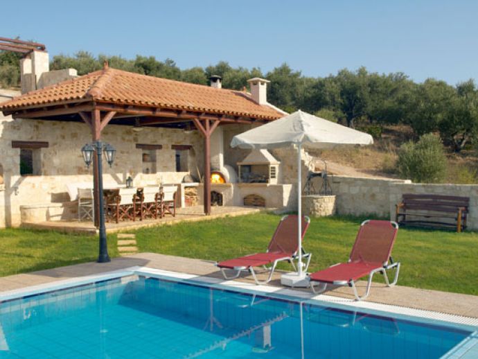 Pool with sun loungers and umbrellas